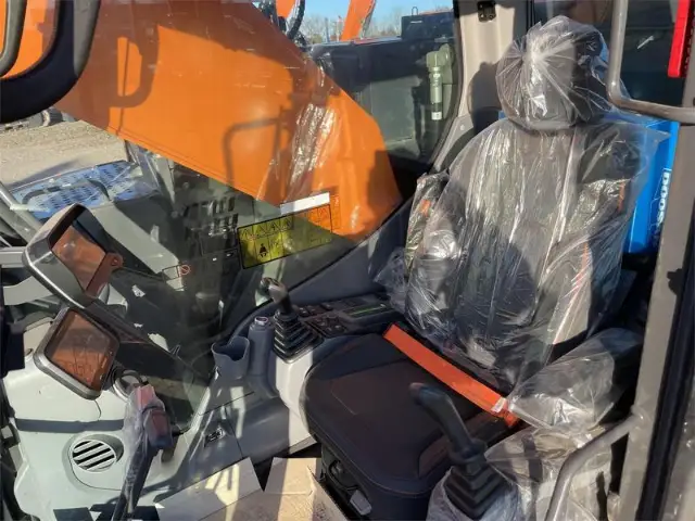 Operator cab with the seat still in its factory plastic